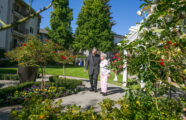 Asian Couple Walking in Rose garden Courtyard