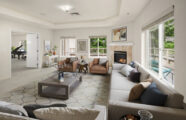 University House Issaquah retirement community apartment living room with fireplace