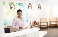 woman at reception welcoming guests to the wellness clinic