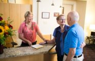 Registered nurse helping two residents in the wellness clinic