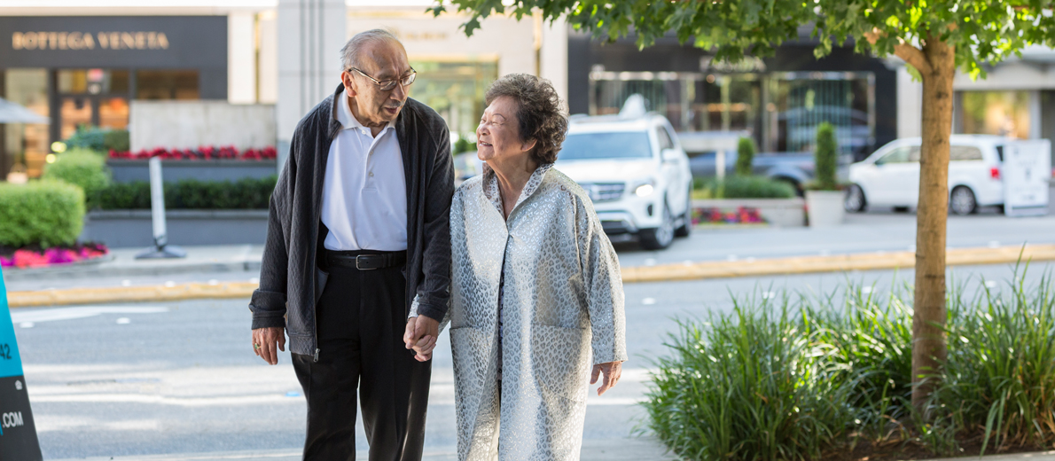 Senior couple walking down the sidewalk