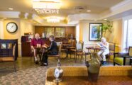 Senior citizens enjoying drinks at a cafe in senior living community
