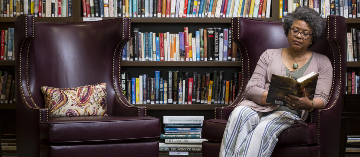 Senior enjoying library at The Gardens at Town Square in Bellevue, WA