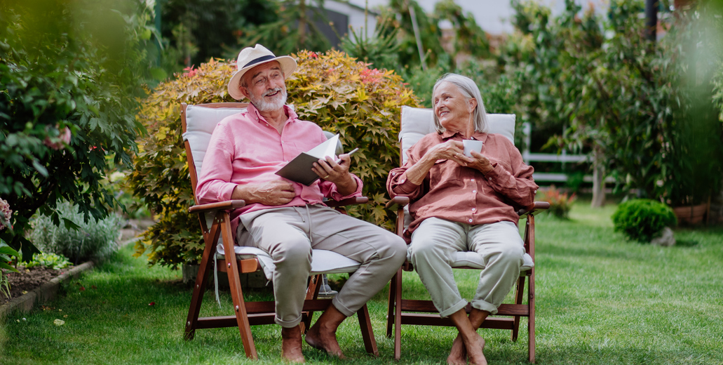 A happy couple sitting outside enjoying the beauty of nature.