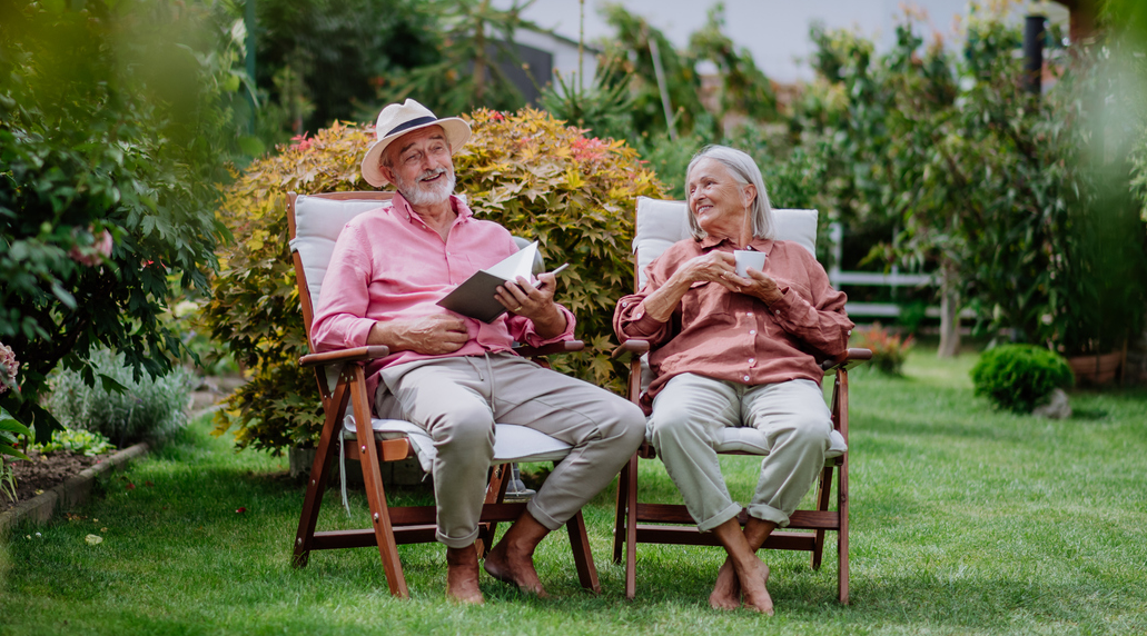 A happy couple sitting outside enjoying the beauty of nature.