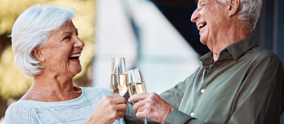 Older couple toasting with champagne