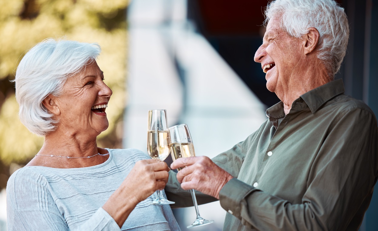 Older couple toasting with champagne