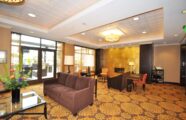 An elegant common area at the Aljoya Thornton Place retirement community in Seattle, featuring a fireplace and comfortable seating for relaxation and connection.