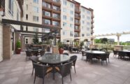 Serene outdoor courtyard at the Aljoya Thornton Place retirement community in Seattle, featuring spacious, comfortable seating and expansive views.