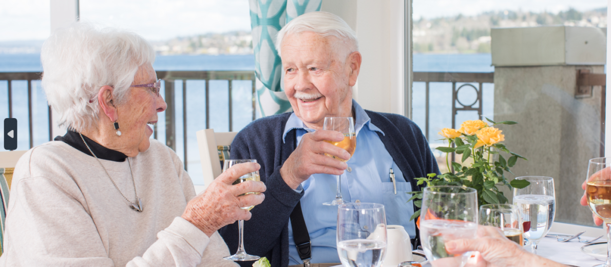 Two smiling residents enjoying lunch together