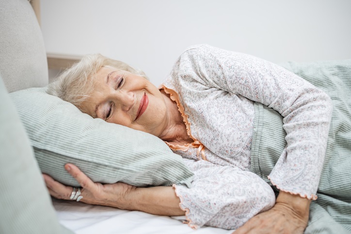 Smiling older woman sleeping peacefully