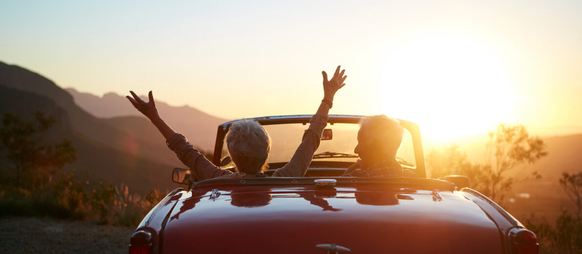 Shot of a joyful senior couple enjoying the sunset during a roadtrip