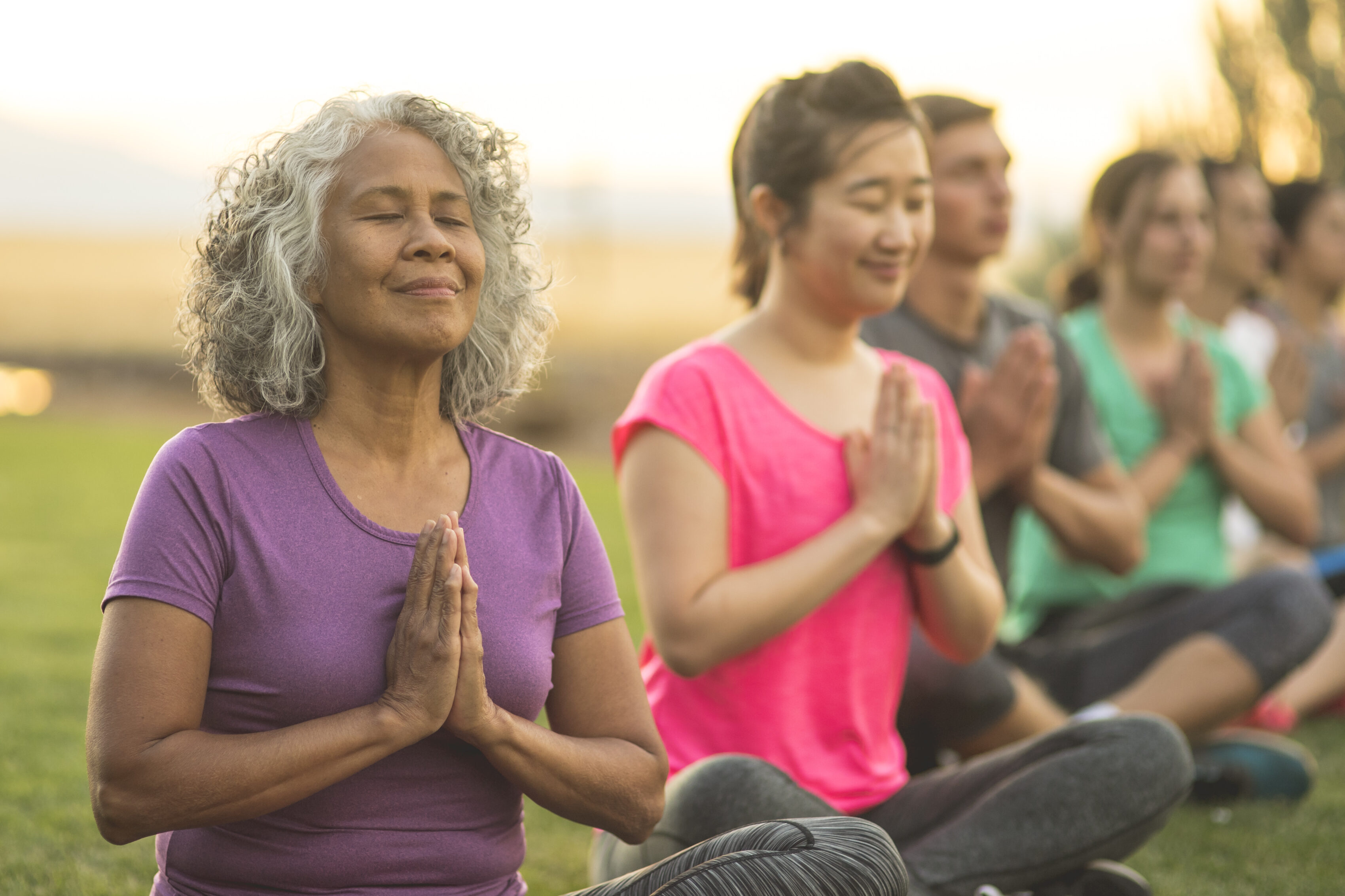 Women meditating to manage stress